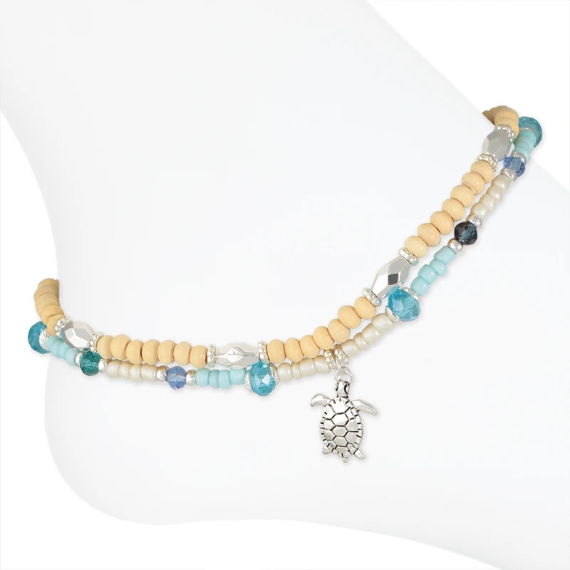 Double layer sea turtle beaded anklet with wooden beads and blue teal crystal beads on white background — coastal beach anklet — Crabby Mermaid
