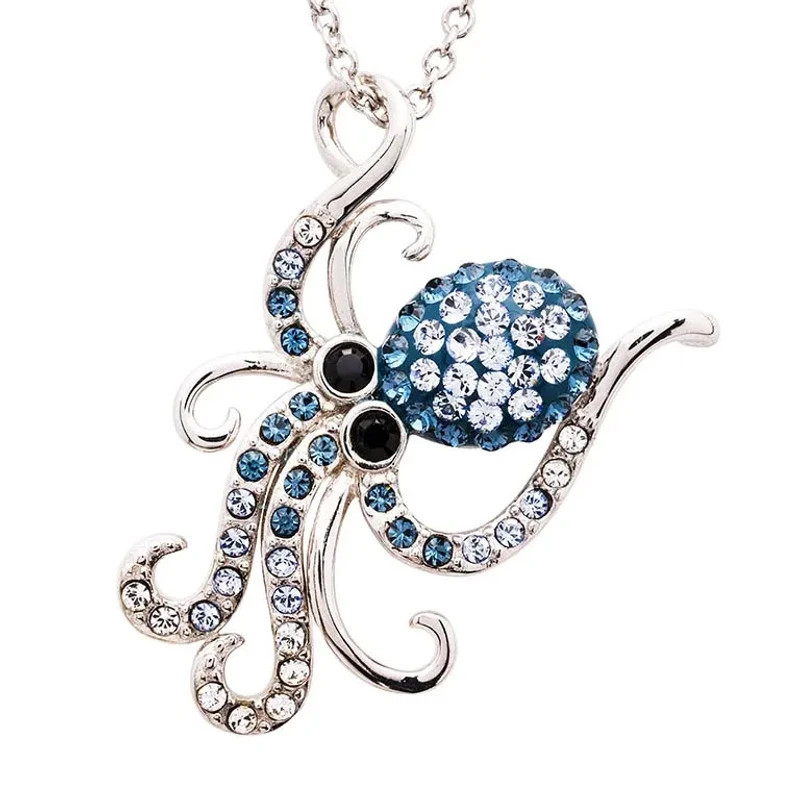 Sterling silver octopus pendant necklace with blue and clear crystals and black eyes on white background — Crabby Mermaid