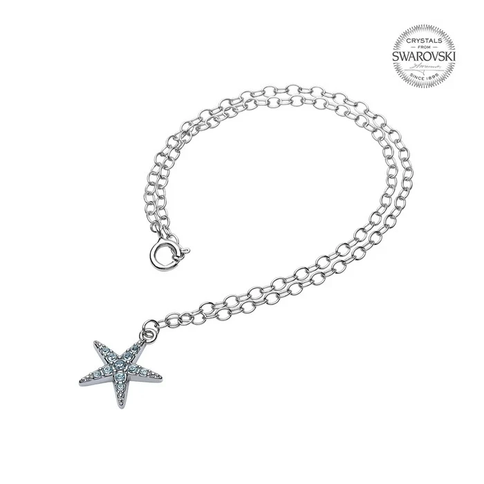 Sterling silver starfish anklet with aqua Swarovski crystals worn on model at beach — handcrafted in Ireland — Crabby Mermaid