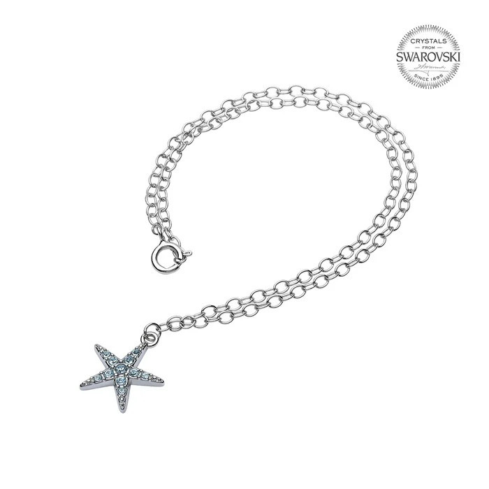 Sterling silver starfish anklet with aqua Swarovski crystals worn on model at beach — handcrafted in Ireland — Crabby Mermaid