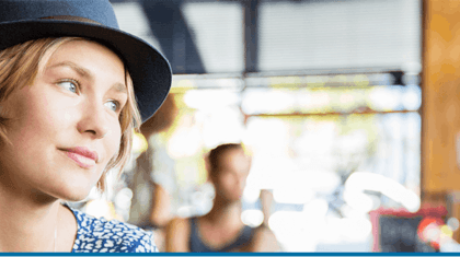 Woman wearing a hat in a shop