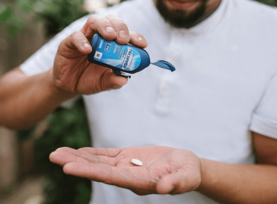Guy places lozenge in palm and doesn't smoke