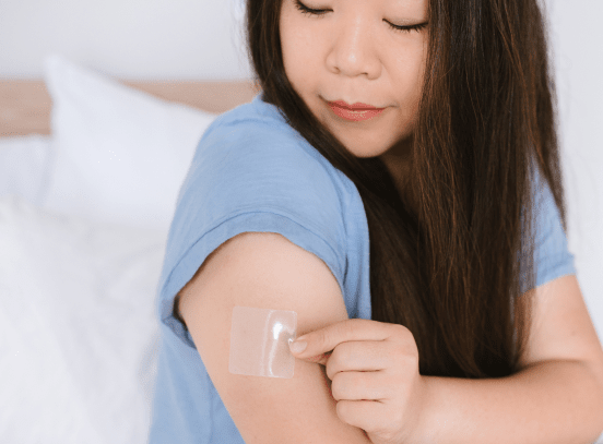 Woman places patch on arm and doesn't smoke