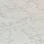 A close-up of a white marble look countertop with a veined pattern. The veining is gray and appears to run throughout the entire surface of the countertop in a web-like pattern.