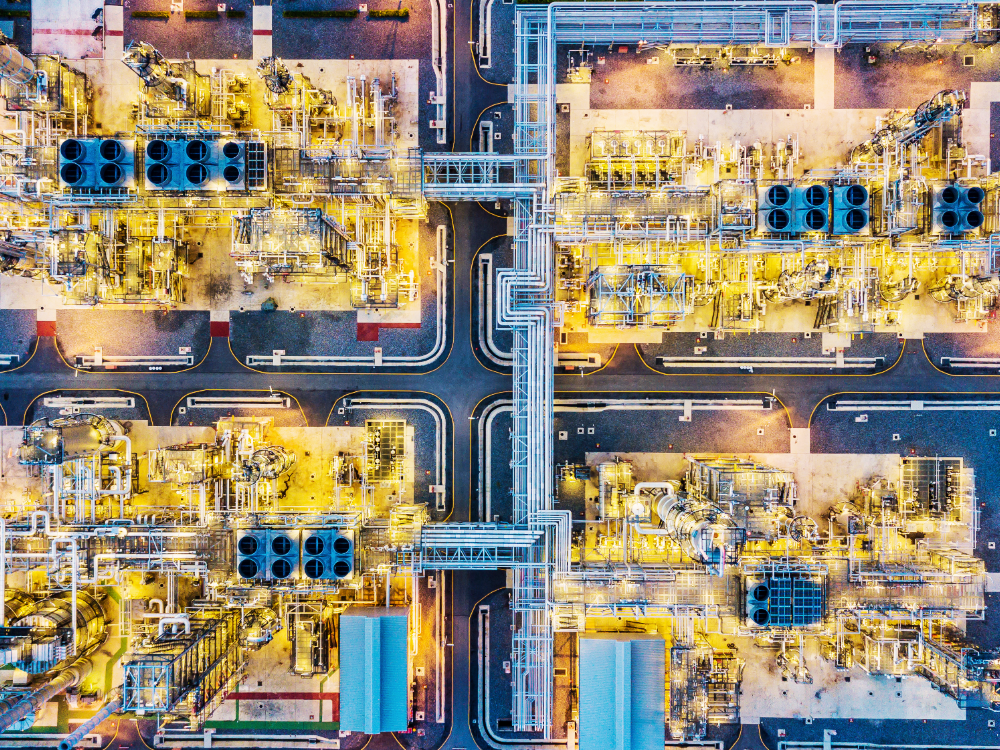 Bird's eye view of an oil refinery at night.