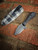 TANG~M (CHARCOAL DYMALUX/BLACK G10/GREY PLAID)