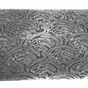 Close-up texture of stainless Damascus billet with waves pattern