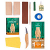 Flat lay of BeaverCraft DIY12 Standing Bear Carving Kit with knife, basswood, strop, linseed oil and booklet