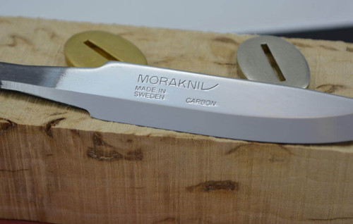 Close-up of Mora 75 blade in a kit with bolster and solid wooden handle block. This item for sale is the blade only, not the entire kit