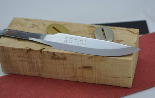 Close-up of Mora 75 blade in a kit with bolster and solid wooden handle block. This item for sale is the blade only, not the entire kit