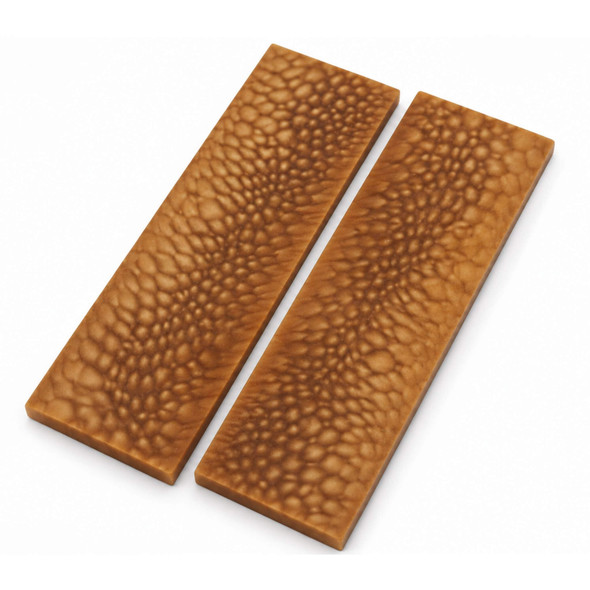 Pair of Honey Dragon resin knife handle scales in warm honey-brown with a distinctive dragon-scale pattern, shown side by side on a white background.