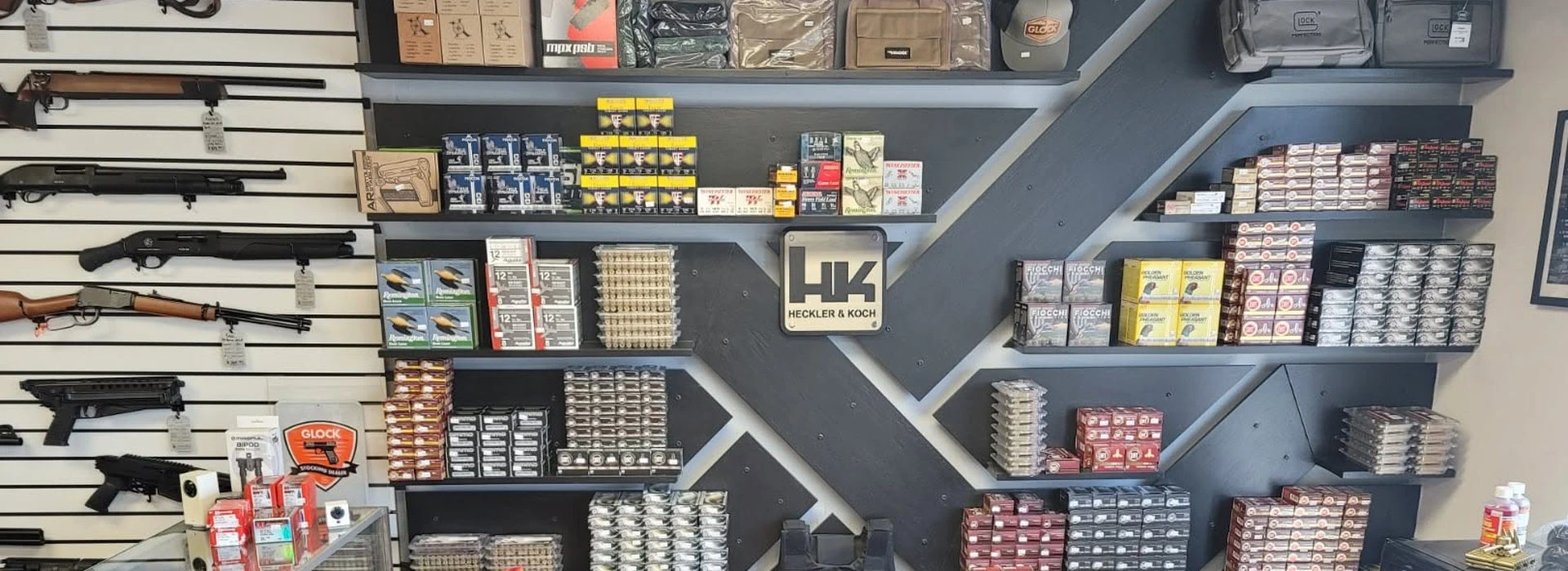 Rifles, ammunition and range bags on the shelves inside the Gun Gear Warehouse store in Oak Grove, Missouri