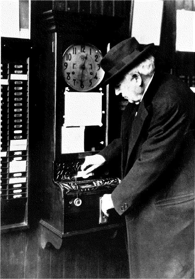 Thomas Edison using a time clock, 1921