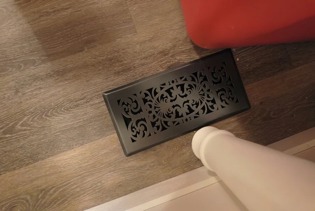 Black wall vent cover in dark interior