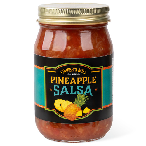 A 16-ounce glass jar of Cooper's Mill Pineapple Salsa with gold screw-on lid. Black and teal label shows an illustration of pineapples.
