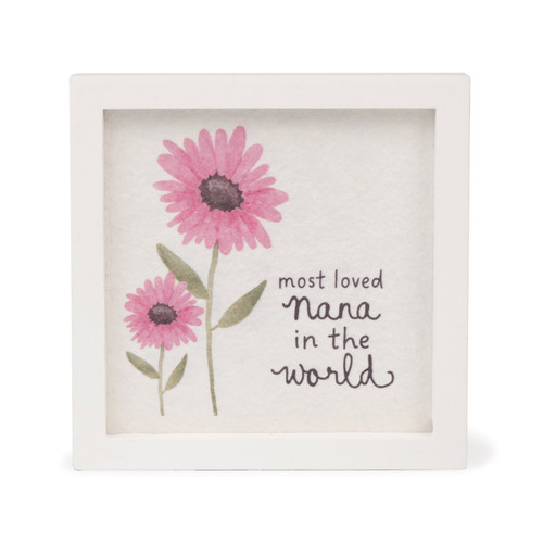 A square white-framed sign featuring a printed watercolor-style illustration of two pink daisies and the text, "most loved Nana in the world."
