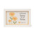 A rectangular white-framed sign featuring a printed watercolor-style illustration of yellow daisies and the text, "A friend loves at all times. Proverbs 17:17."