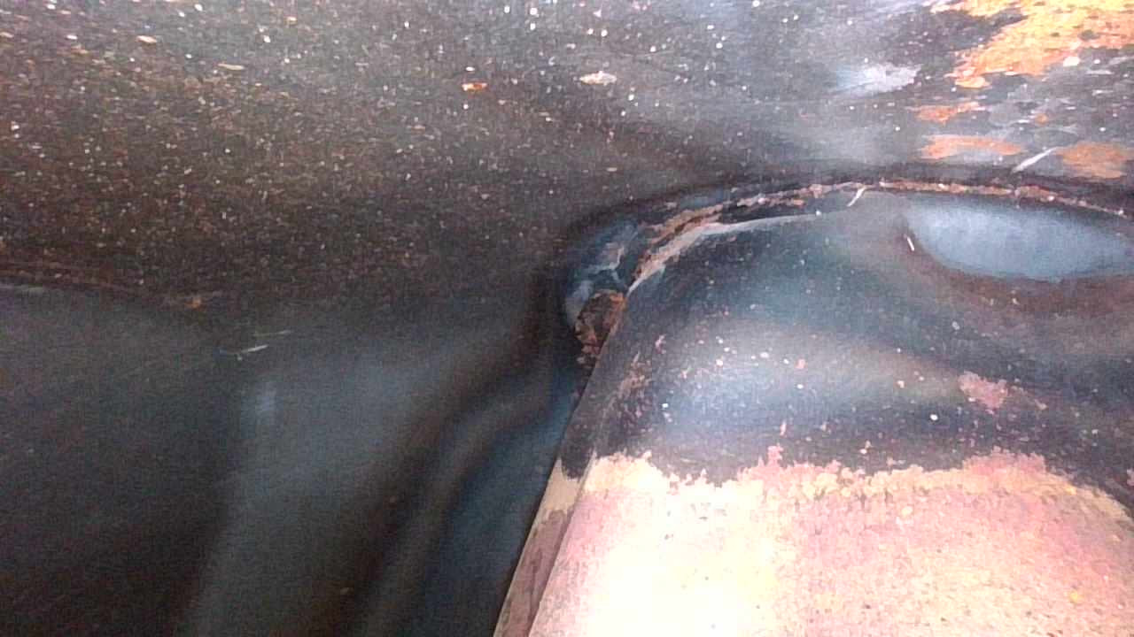 Inside edge at the top of the fuel tank.