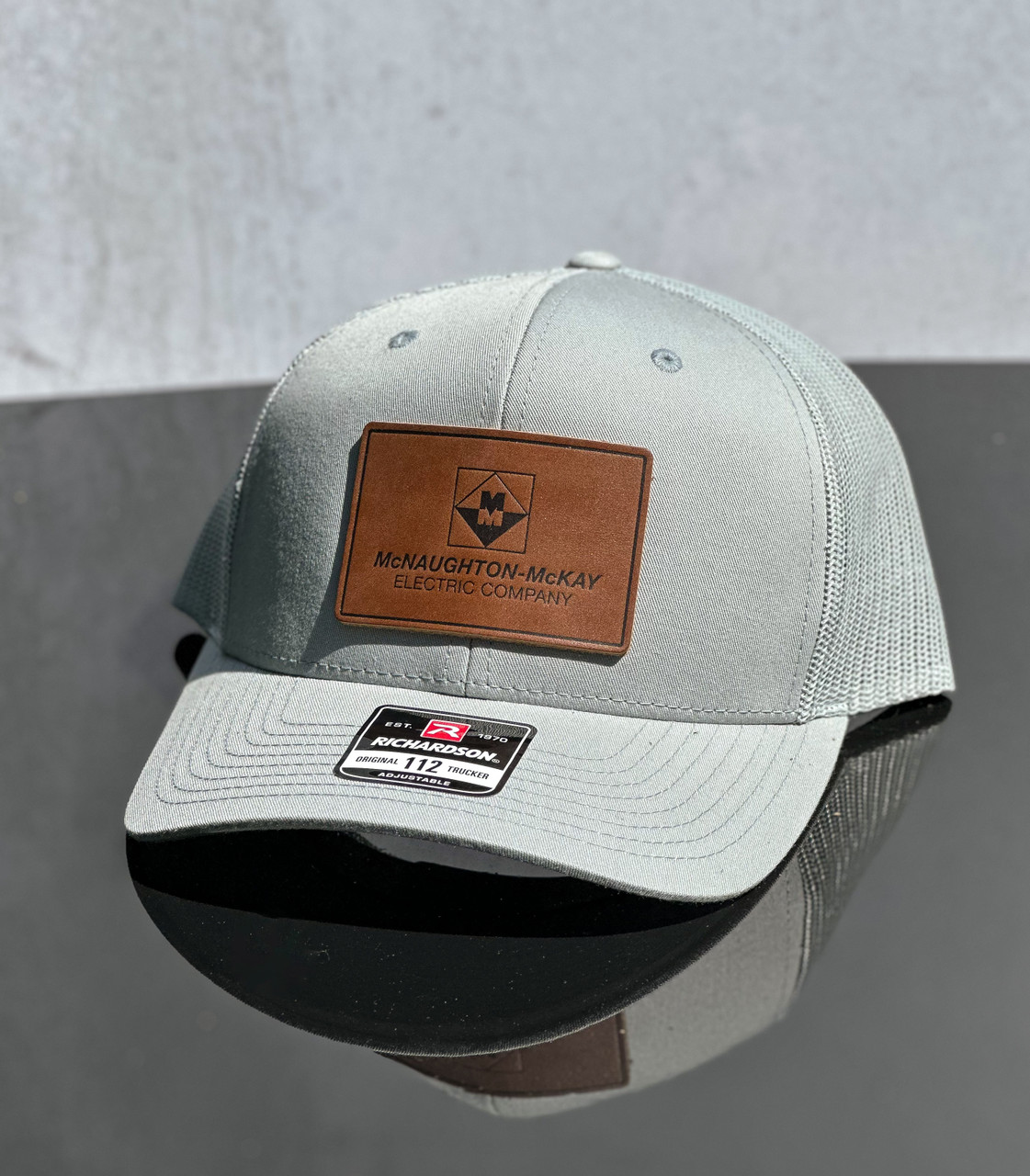 We The Essentials Camo Trucker Hat with Leather Patch