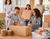 family using Peppergrass packing tape to seal moving boxes at home with tape dispenser