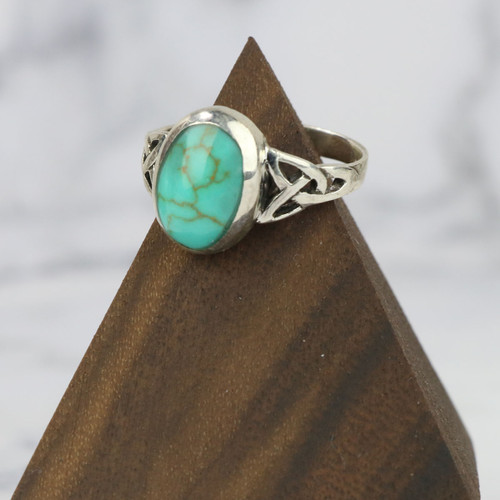 A Celtic Triquetra (Trinity Knot) ring featuring a detailed interwoven design accented with a turquoise gemstone centerpiece. Symbolizing eternity, unity, and protection, this clearance piece is available only while supplies last.