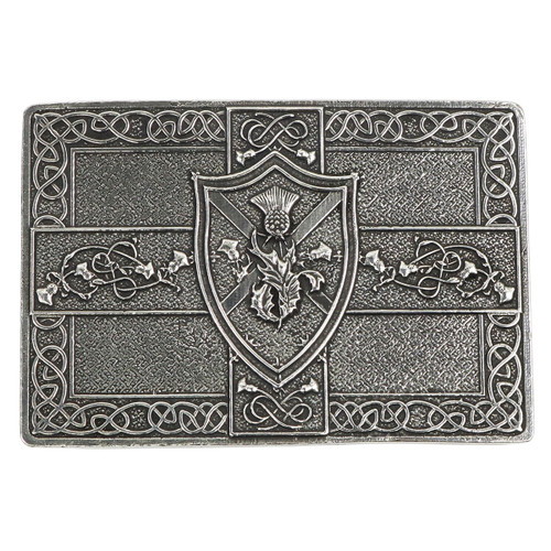 Close-up of Saltire and thistle shield kilt buckle showing traditional Scottish symbols.