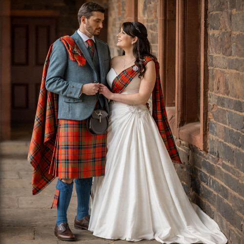 Traditional Celtic wedding attire featuring groom in tartan kilt and bride wearing wedding gown with tartan sash