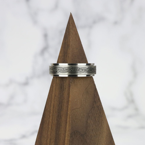 A stainless steel spinner ring featuring a detailed Celtic knot engraving on the rotating outer band. Symbolizing eternity and unity, this heritage-inspired piece doubles as a discreet fidget ring. On sale while supplies last.
