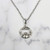 Sterling Silver Triquetra Claddagh Necklace on background
