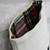 A detailed view of the tartan cuff on a holiday stocking showcasing vibrant plaid patterns and fine stitching.