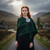 Woman wearing Traditional Scottish plaid brooch with fighting stags design worn on tartan sash for Highland formalwear