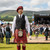 Male model wearing a homespun wool blend tartan tam with matching tartan kilt and traditional Highland outfit outdoors in rustic Celtic setting