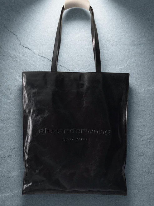 Alexander Wang Black Large Tote Bag front view hanging in sleek glossy finish with brand logo on the front
