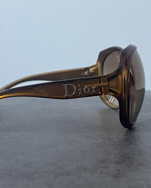 Christian Dior Glossy Oversized Sunglasses  side view showing brown gold frame with engraved Dior branding on the arm