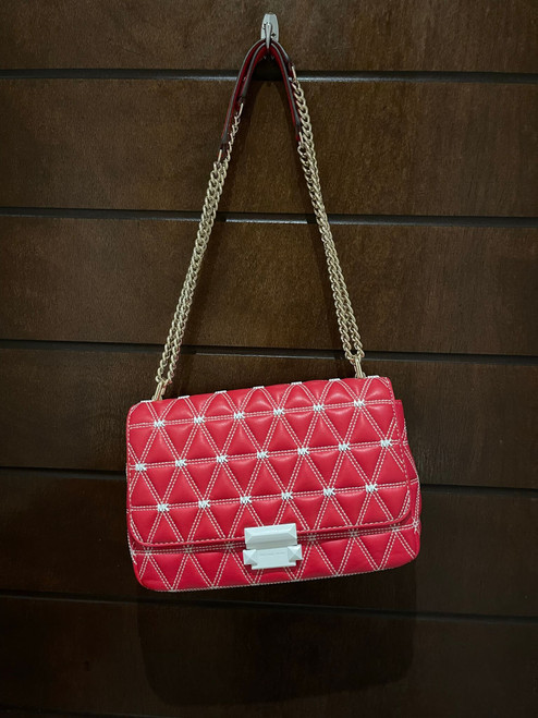 Michael Kors Red Leather Crossbody Bag front view hanging from gold chain & white quilted stitching & push-lock clasp