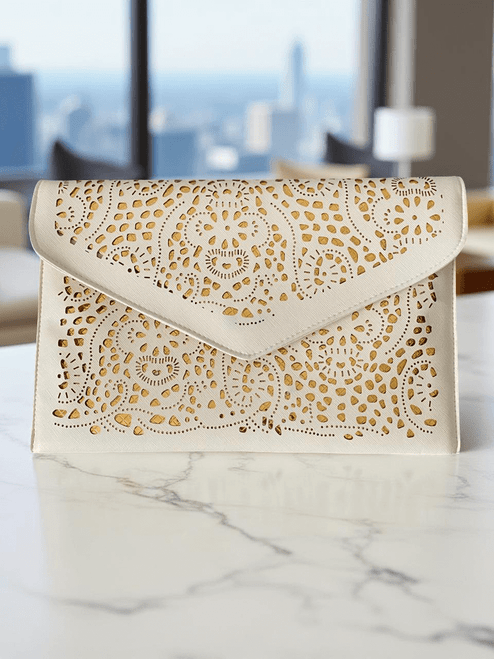 Ivory Laser-Cut Envelope Clutch front view with detailed floral cut-out design with gold underlay