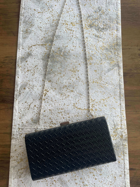 Black Woven Crossbody Box Clutch Top view in faux leather with long silver chain strap laid flat