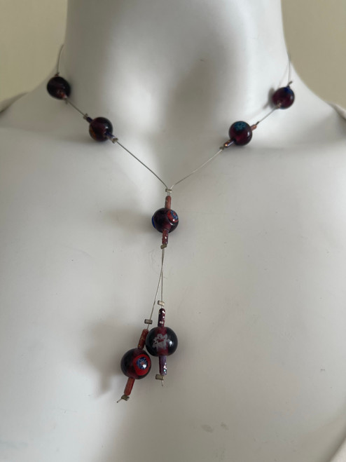 Purple Beaded Wire Necklace front view with dark round beads on fine silver wire & inner blue, green, yellow flower detail