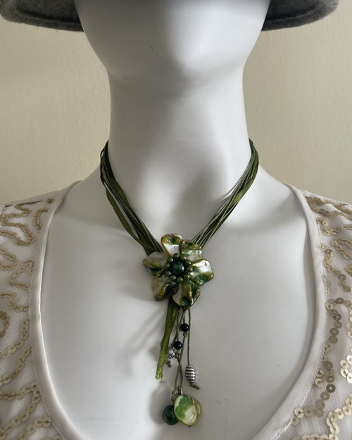 Green Flower Pendant Necklace front view on mannequin - layered green olive fabric strands, flower pendant & bead detail