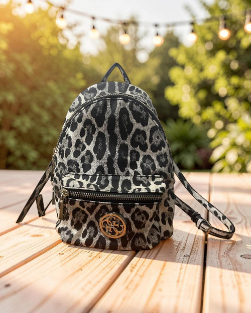 Guess Leopard Print Backpack front view in black & off-white leopard print, silver logo plaque & front zip pocket