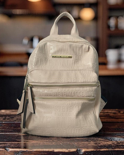 Steve Madden Cream Logo Backpack full front with different sized logos, main + 2 front zip compartments with gold hardware