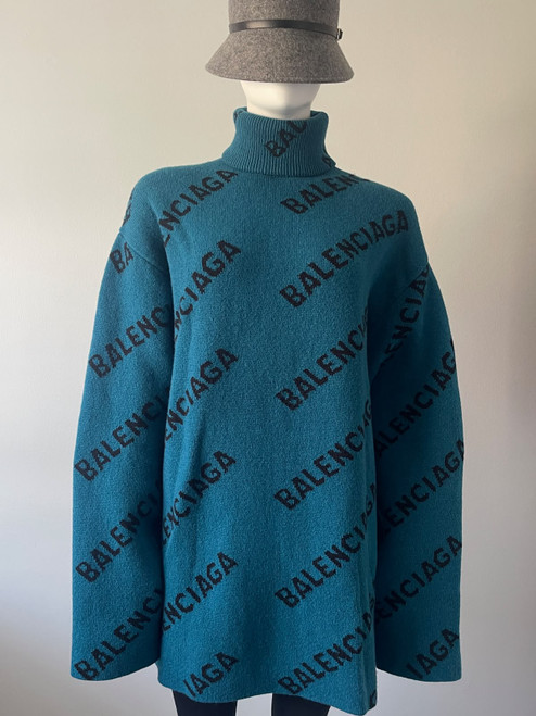 Balenciaga Oversized Teal Monogram Wool Jersey front view in petrol teal blue with black diagonal logos & long sleeves