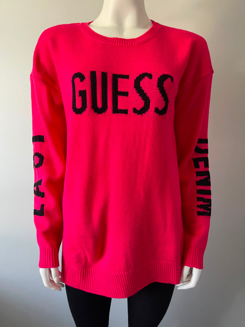 Guess Neon Fuchsia Logo Knit Sweater closer front view with long sleeves, GUESS black chest logo, ribbed neck, cuffs & hem