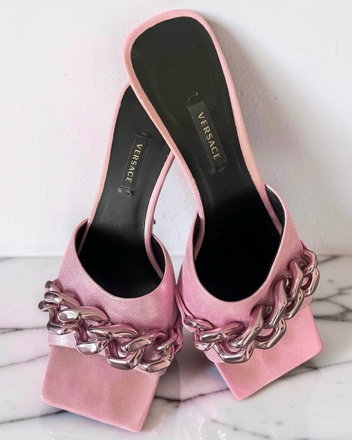Versace Metallic Pink Suede Chain Heel Sandals leaning against a white wall in metallic finish & pink chunky chain on the toes