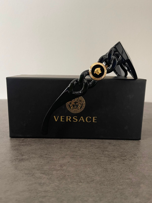 Versace Medusa Black Chain Link Sunglasses resting on black Versace branded sunglasses box