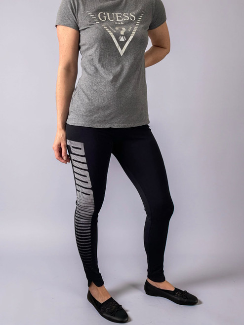 Puma Black Striped Logo Leggings angled from view in black with Puma striped branding down the left leg & split hems