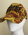 Versace Jeans Couture Orange & Yellow Baroque Cap side view on mannequin with black embroidered logo & baroque print