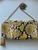 Aldo Yellow Snake Print Crossbody Envelope Clutch back view with  matching wristlet, gold chain & black, yellow & white print