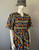 Charlie Irish African Inspired Midi Dress angled front view showing V neckline, wide sleeves, bold print & relaxed fit