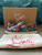 Christian Louboutin Skull Print Slip-On Spike Sneakers front side profile in colorful print with original box & white dustbag